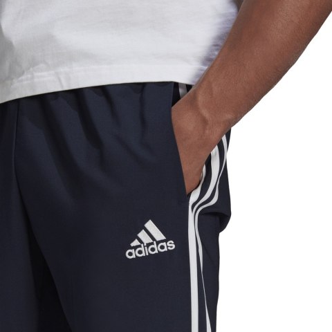 Adidas Spodnie męskie adidas Essentials Tapered Cuff 3 Stripes Pants granatowe GK8981 Adidas Spodnie męskie adidas Essentials Tapered Cuff 3 Stripes Pants granatowe GK8981