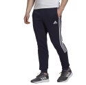 Adidas Spodnie męskie adidas Essentials Tapered Cuff 3 Stripes granatowe GK8977 Adidas Spodnie męskie adidas Essentials Tapered Cuff 3 Stripes granatowe GK8977