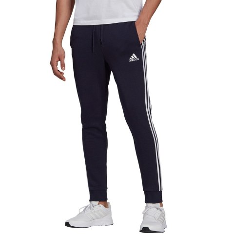 Adidas Spodnie męskie adidas Essentials Fleece Tapered Cuff 3-Band Pants granatowe GK8823 Adidas Spodnie męskie adidas Essentials Fleece Tapered Cuff 3-Band Pants granatowe GK8823